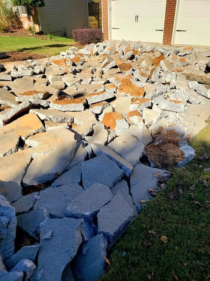 Cracked concrete driveway broken out and ready for haul-off